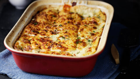 lasagna in dark red baking dish